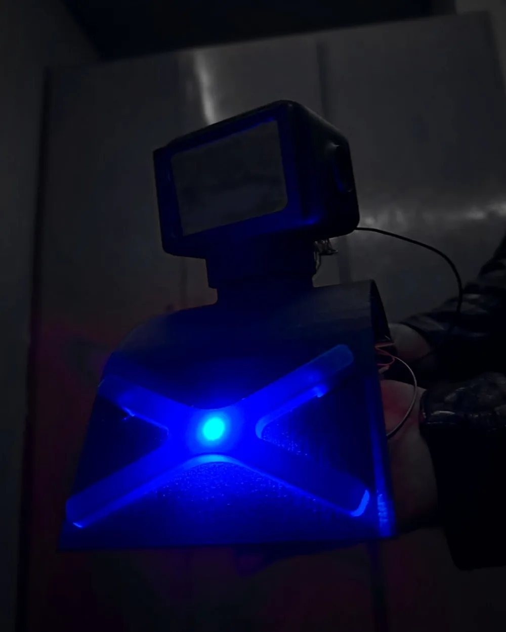 V1 in the dark with its X emblem lit blue